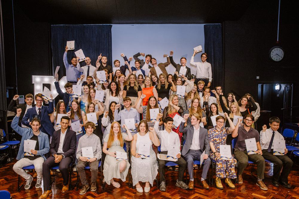 Group photo of students and staff at results evening.