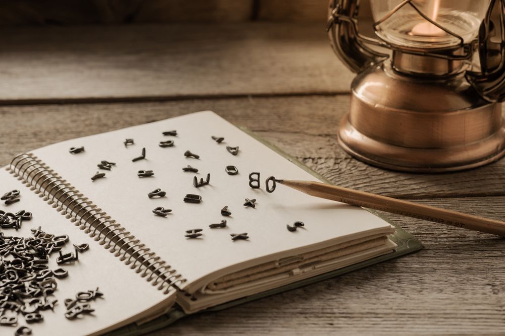 Image of book, letters and pen on a desk