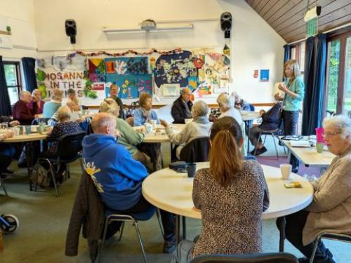 A group of mature students listening to tutor Alison